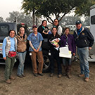 Veterinarians pose next to horse trailer