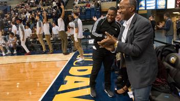 Chancellor May cheers courtside at the last home basketball game of the season. 