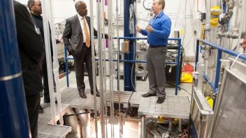 Director Wesley D. Frey talks about ongoing work as Chancellor Gary May tours with school deans the McClellan Nuclear Research Center on January 11, 2018. They are standing above the reactor.