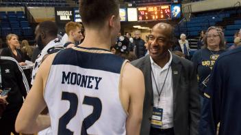 Chancellor Gary May congratulates Aggie basketball player on a good game at the ARC Pavilion. 