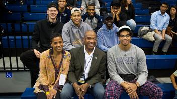 Chancellor May and his wife LeShelle May cheer on the women’s basketball team with a group of student athletes. 