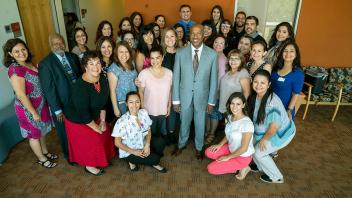 Chancellor Gary May takes a photo with the Latinx Staff and Faculty Association.
