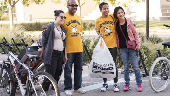 Chancellor Gary May and LeShelle May pose for a photo with students during Move-in Day at Tercero Residence Halls.