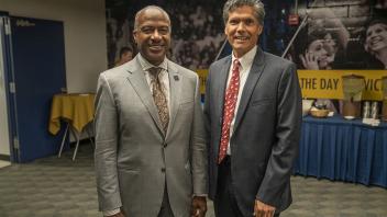 UC Davis Chancellor Gary May smiles next to the mayor of the City of Davis, Brett Lee.