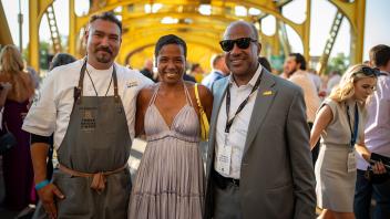 LeShelle and Chancellor Gary May pose for a photo with Santana Diaz