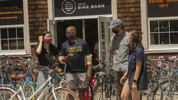 Chancellor May talks beside dozens of bicycles at the bike barn. 