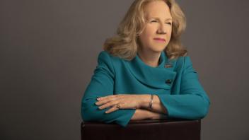 provost mary croughan in a chair