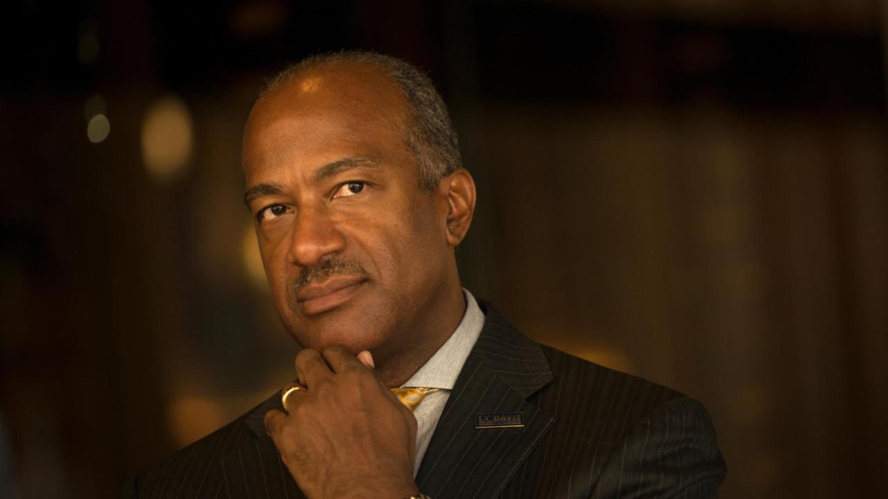 Chancellor may looking away from the camera with his chin on his hand.
