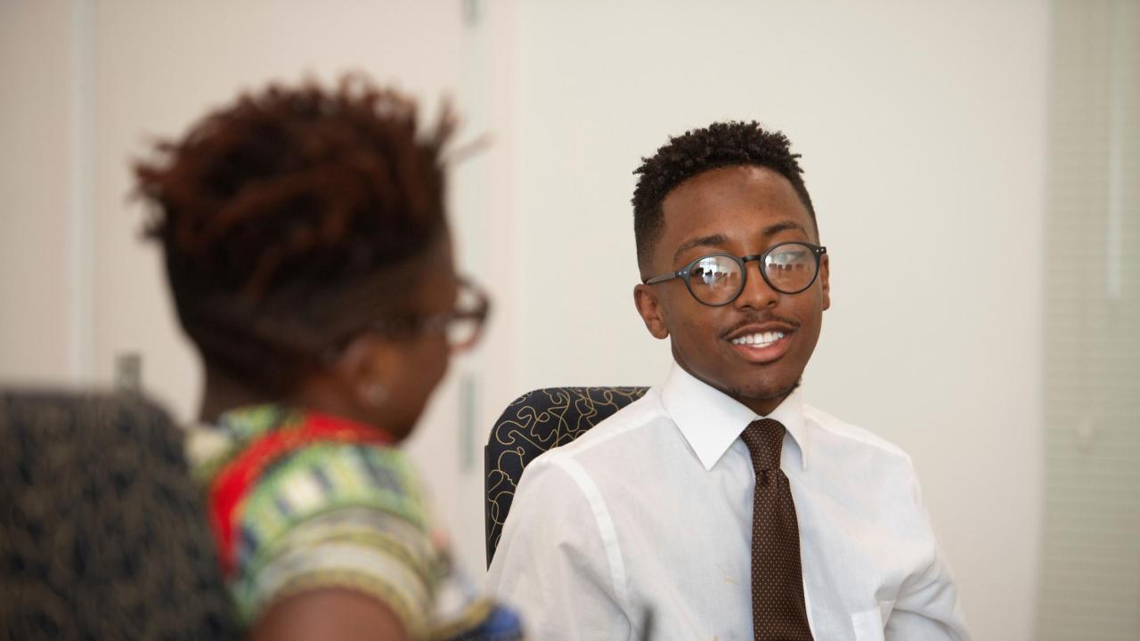 Davares Robinson, shown during his Leadership Job Shadow where he was paired with Chancellor Gary S. May, heads to University of San Francisco for graduate school in the fall. UC Davis student Davares Robinson talks to a fellow student.