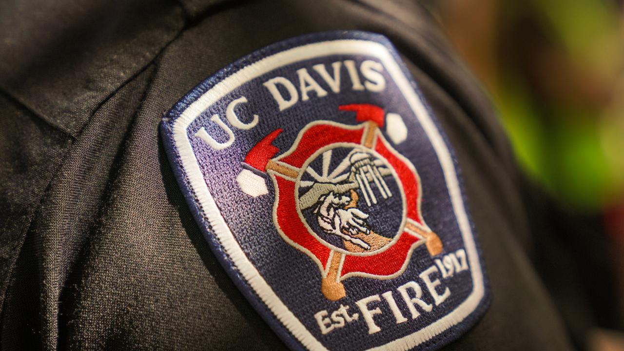 Photo of the UC Davis Fire Department badge on a dark sleeve.