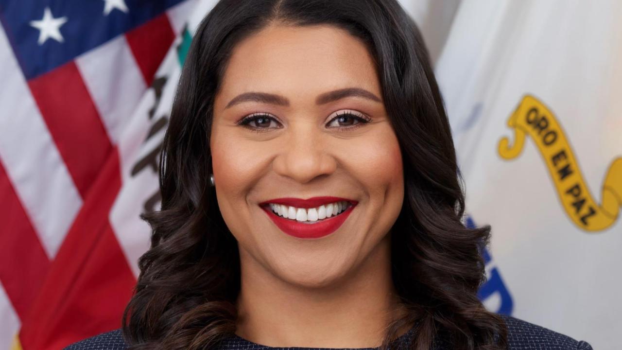 Mayor London Breed in front of American flag