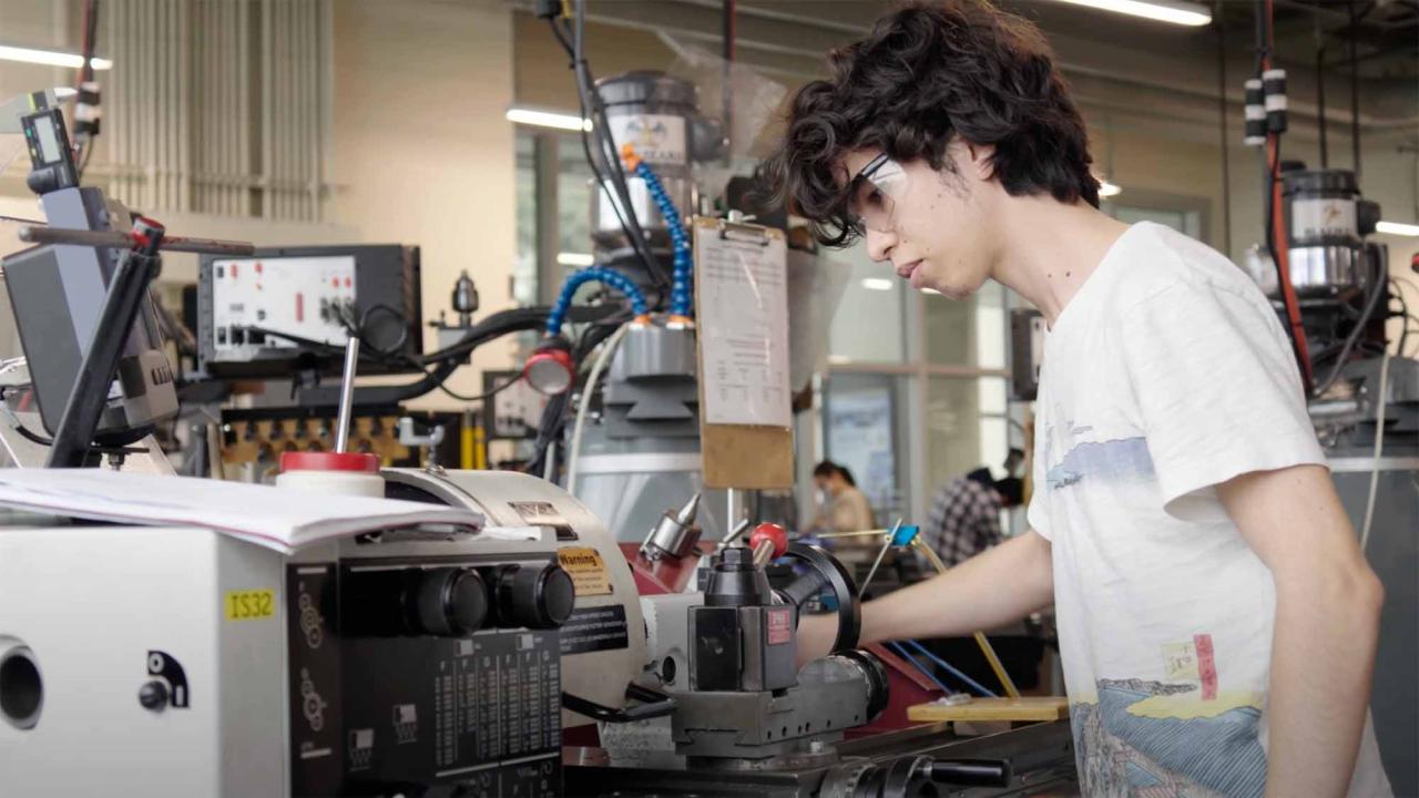 Student working on machine in engineering center