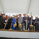 Group photo of Chancellor Gary May with other leaders digging into dirt with golden shovels