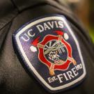 Photo of the UC Davis Fire Department badge on a dark sleeve.