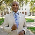Chancellor May standing in front of Mrak Hall and Eye on Mrak Egghead.